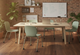 Aarhus Wheelie Chairs by Quell Design in soft morandi green arranged around a rectangular table in a modern office setting with exposed red brick walls and light wooden flooring. These Scandinavian-style ergonomic chairs feature smooth moulded polypropylene seats and black five-star swivel bases with castors, combining mobility, comfort, and minimalist design for collaborative learning environments.