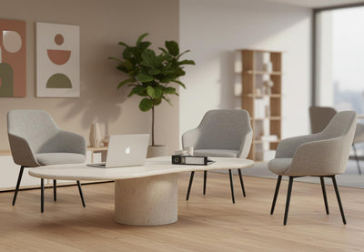 Keebu Office Lounge Chairs arranged around a marble coffee table in a contemporary breakout room, featuring three upholstered lounge chairs set on wooden flooring with beige and white walls, tall ceilings and large windows, highlighting modern lounge seating for office and collaborative environments.