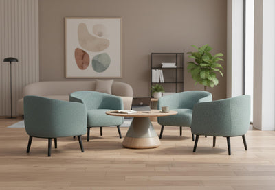 Keebu Breakout Lounge Chairs arranged in a comfortable breakout room, featuring four upholstered lounge chairs on wooden flooring with beige walls and high ceilings, showcasing modern seating for relaxed office and collaborative spaces.